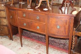 A Georgian style mahogany and crossbanded sideboard with two central drawers flanked by a deep
