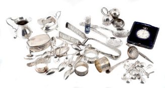 A collection of silver items, to include: a pair of asparagus tongs by... A collection of silver