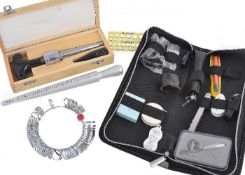 A group of jewellers items, including; ring sizers; a diamond tester; and various other gem