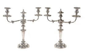 A pair of electro-plated three light candelabra, with gadrooned borders A pair of electro-plated