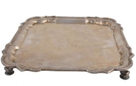 A silver shaped square salver by C. S. Harris & Sons Ltd A silver shaped square salver by C. S.