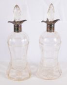 A pair of waisted cut glass decanters with silver collars by Lee & Wigfull A pair of waisted cut