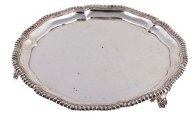 An Edwardian shaped circular silver salver by Elkington & Co An Edwardian shaped circular silver