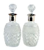 A pair of cut glass decanters with silver collars by Mappin & Webb Ltd A pair of cut glass decanters