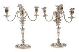 A pair of electro-plated five light candelabra, with reeded borders A pair of electro-plated five