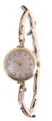 An 18 carat gold lady`s wristwatch, the circular case with a silvered dial An 18 carat gold lady`s