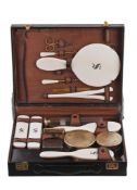 A leather cased sixteen piece ivory and silver mounted dressing table set by G A leather cased