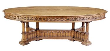 A Victorian Gothic Revival oak library table, circa 1860, the oval top with moulded edge, above a