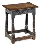 A James I oak joint stool, circa 1610, the solid rectangular seat with moulded edge above a