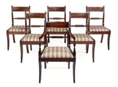 A set of twelve George IV mahogany dining chairs, circa 1825, to include a pair of armchairs, each