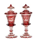 A pair of Bohemian clear glass and ruby flashed pedestal goblets and covers, third quarter 19th