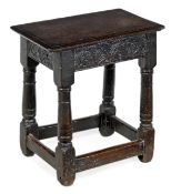 A James I oak joint stool, circa 1610, the solid rectangular seat with moulded edge above a