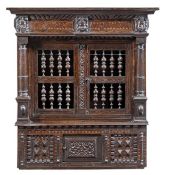 A Charles I oak and inlaid hanging mural cupboard, circa 1630, the moulded cornice above a chevron