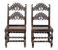 A pair of Charles II oak backstools, Derbyshire, circa 1660, each rectangular back with a pair of