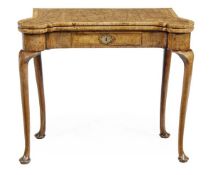 A George I walnut and burr walnut folding games table, circa 1720, the rectangular crossbanded and