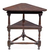 A George II oak triangular table, circa 1740, the top and undertier with a moulded frieze and with