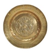 A Nuremberg brass alms dish, late 16th century, with raised rim above the flat edge stamped with