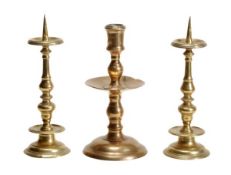 A pair of English or Dutch brass pricket candlesticks, early 17th century, with shallow dished