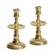 A pair of Dutch Heemskerk candlesticks, mid 17th century, the sockets on knopped stems with broad,