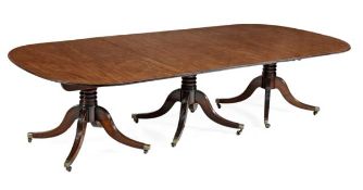 A George III mahogany triple pillar extending dining table, circa 1800, with two additional leaf