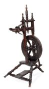 A George II turned and carved oak spinning wheel of small proportion, mid 18th century, the wheel
