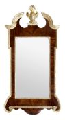 A George II mahogany and parcel gilt wall mirror, circa 1750, the rectangular plate within a