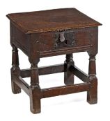 A Charles I oak box seat stool, circa 1630, the hinged rectangular seat with moulded edge above a