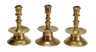 A pair of Dutch brass ‘capstan’ candlesticks, circa 1600, the sockets both with two extraction