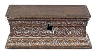 A Charles I oak bible box, circa 1630, the hinged lid above a guilloche and patera carved frieze