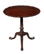 A George III mahogany tripod table, circa 1760, the circular top with a profusely acanthus carved