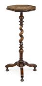A William and Mary walnut candlestand, circa 1690, the octagonal oyster veneered top with holly