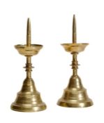 A pair of Continental brass pricket candlesticks, 17th century with later elements, the prickets