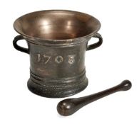 A Queen Anne bronze mortar, dated 1708, the flared rim knopped to the exterior, above twin handles,
