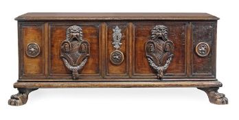 An Italian carved walnut cassone, 17th century, the hinged lid above a pair of iron side carrying