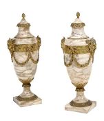 A pair of Continental gilt bronze mounted variegated cream marble urns in Louis XVI style, circa