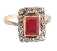 A synthetic ruby and diamond cluster ring A synthetic ruby and diamond cluster ring, the step cut