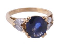 A sapphire and diamond ring, the oval cut sapphire in a claw setting A sapphire and diamond ring,
