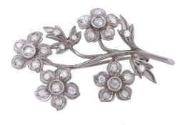 A diamond spray brooch, of foliate design A diamond spray brooch, of foliate design, the flower