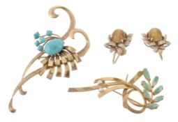 A turquoise brooch, of stylised form, set with oval and circular cabochon... A turquoise brooch, of