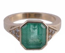 An emerald and diamond ring, the central step cut emerald with canted... An emerald and diamond