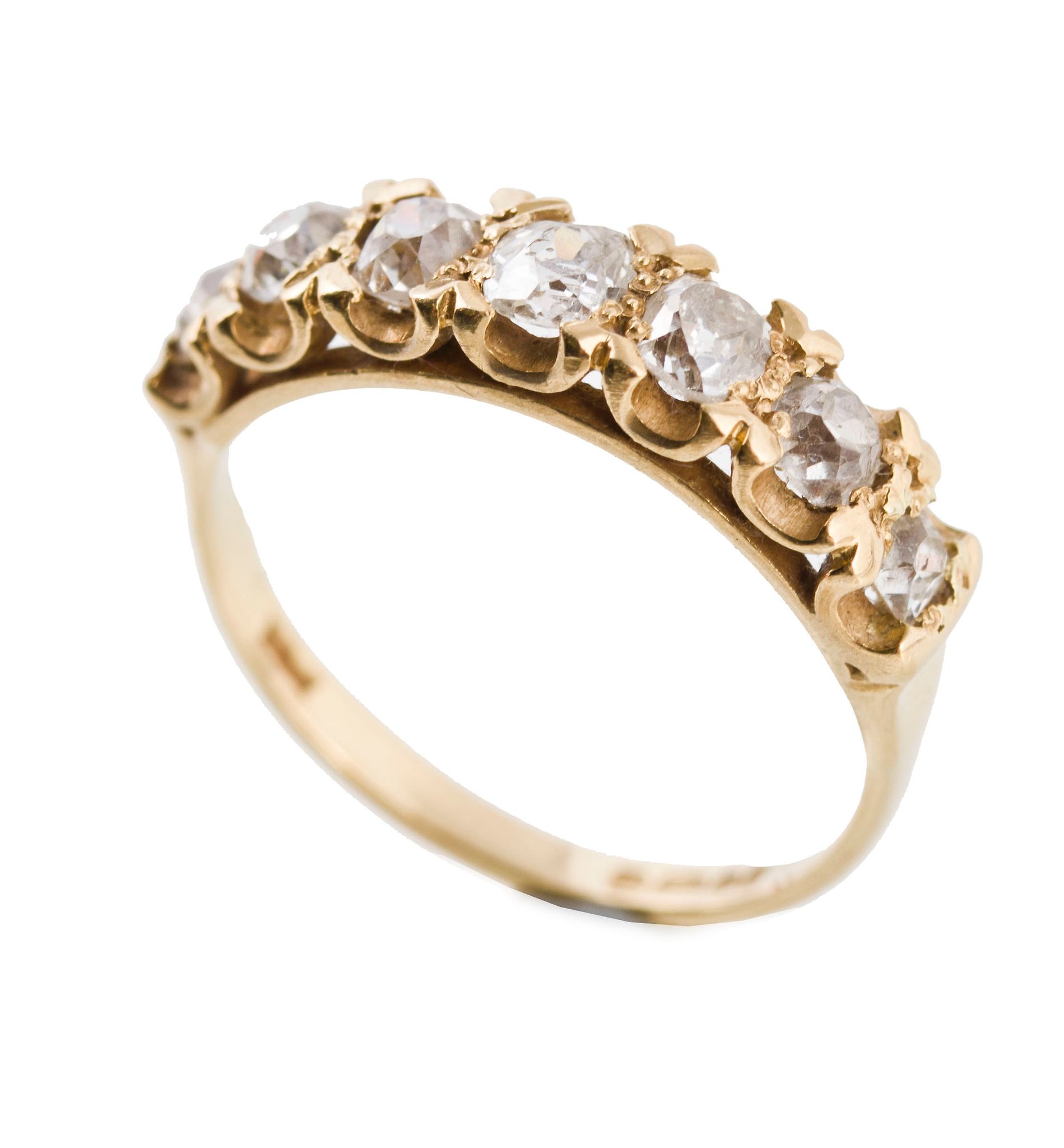 An 18 carat gold diamond ring, with seven claw set old cut diamonds An 18 carat gold diamond ring,