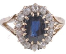 A sapphire and diamond cluster ring, the central oval cut sapphire in a claw... A sapphire and