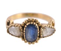 A sapphire and diamond ring, the central oval cut sapphire between two rose... A sapphire and