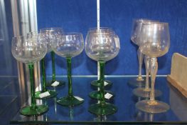 Seven hock glasses with green stems and three Venetian wine glasses