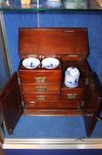 An early 20th Century smokers cabinet with Art Nouveau style marquetry decoration to the front