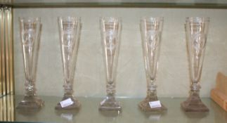 Five engraved champagne flutes; 21.5cm high each