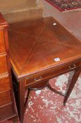 An Edwardian mahogany and crossbanded envelope card table with a frieze drawer on square tapering
