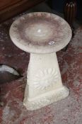 A stone effect bird bath 62cm high and a metal statue of a heron. Best Bid