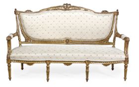 A Victorian giltwood framed and upholstered settee, circa 1880, the shaped overstuffed back