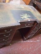 An Edwardian inverted breakfront mahogany kneehole desk with nine short drawers 79cm high, 99cm